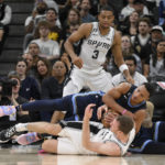 
              San Antonio Spurs' Jakob Poeltl, bottom, and Memphis Grizzlies' Desmond Bane scramble for the ball as Spurs forward Keldon Johnson (3) watches during overtime of an NBA basketball game Wednesday, Nov. 9, 2022, in San Antonio. The Grizzlies won 124-122. (AP Photo/Darren Abate)
            