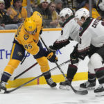 
              Nashville Predators' Alexandre Carrier (45) battles for the puck with Arizona Coyotes' Clayton Keller (9) and Jakob Chychrun (6) in the second period of an NHL hockey game Monday, Nov. 21, 2022, in Nashville, Tenn. (AP Photo/Mark Humphrey)
            