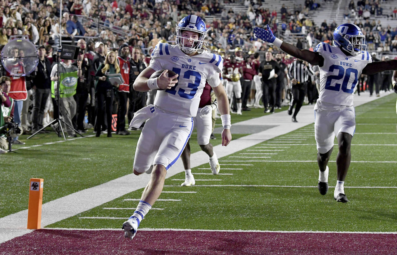 Duke quarterback Riley Leonard (13) runs into the end zone to score during the first half of an NCA...