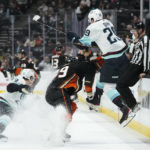 
              Seattle Kraken's Vince Dunn (29) leaps to avoid a check from Anaheim Ducks' Sam Carrick (39) during the first period of an NHL hockey game Sunday, Nov. 27, 2022, in Anaheim, Calif. (AP Photo/Jae C. Hong)
            