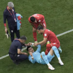 
              Iran's goalkeeper Alireza Beiranvand, in blue jersey, is attended by teammates after he was injured during the World Cup group B soccer match between England and Iran at the Khalifa International Stadium in Doha, Qatar, Monday, Nov. 21, 2022. (AP Photo/Hassan Ammar)
            