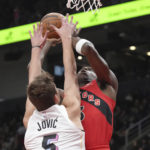 
              Toronto Raptors' O.G. Anunoby, right, scores against Miami Heat's Nikola Jovic during the first half of an NBA basketball game Wednesday, Nov. 16, 2022, in Toronto. (Chris Young/The Canadian Press via AP)
            