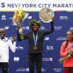
              From left, women's division second place finisher Lonah Chemtai Salpeter, of Israel, winner Sharon Lokedi, of Kenya, and third place finisher Gotytom Gebreslase, of Ethiopia, pose during a ceremony at the finish line of the New York City Marathon, Sunday, Nov. 6, 2022, in New York. (AP Photo/Jason DeCrow)
            