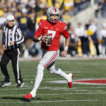 
              Ohio State quarterback C.J. Stroud looks for an open pass against Michigan during the first half of an NCAA college football game on Saturday, Nov. 26, 2022, in Columbus, Ohio. (AP Photo/Jay LaPrete)
            