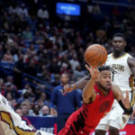 
              Portland Trail Blazers forward Trendon Watford (2) passes between New Orleans Pelicans guard Trey Murphy III, left, and forward Zion Williamson (1) in the second half of an NBA basketball game in New Orleans, Thursday, Nov. 10, 2022. The Trail Blazers won 106-95. (AP Photo/Gerald Herbert)
            
