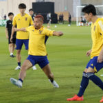 
              Japan's Yuto Nagatomo, left, and his teammates warm up during Japan official training on the eve of the group E World Cup soccer match between Japan and Germany, in Doha, Qatar, Tuesday, Nov. 22, 2022. (AP Photo/Eugene Hoshiko)
            