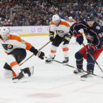 
              Columbus Blue Jackets' Kent Johnson, right, tries to carry the puck past Philadelphia Flyers' Justin Braun during the second period of an NHL hockey game Tuesday, Nov. 15, 2022, in Columbus, Ohio. (AP Photo/Jay LaPrete)
            