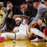 
              Los Angeles Lakers forward Anthony Davis (3) falls into the front row of spectators during the first half of an NBA basketball game against the San Antonio Spurs, Sunday, Nov. 20, 2022 in Los Angeles. (AP Photo/Ringo H.W. Chiu)
            