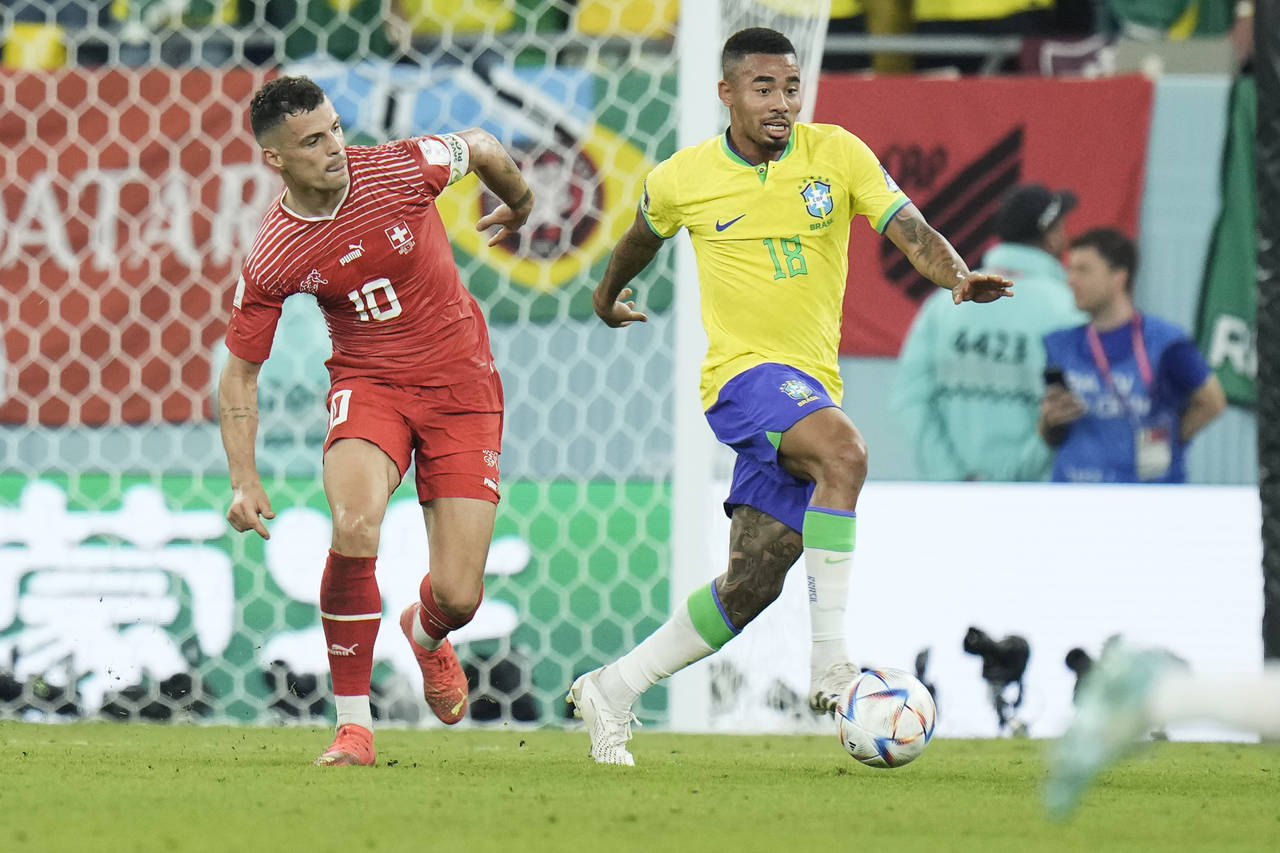 Brazil's Gabriel Jesus, right, and Switzerland's Granit Xhaka challenge for the ball during the Wor...