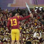 
              Southern California quarterback Caleb Williams leads the USC Marching Band after USC defeat UCLA 48-45 in an NCAA college football game Saturday, Nov. 19, 2022, in Pasadena, Calif. (AP Photo/Mark J. Terrill)
            