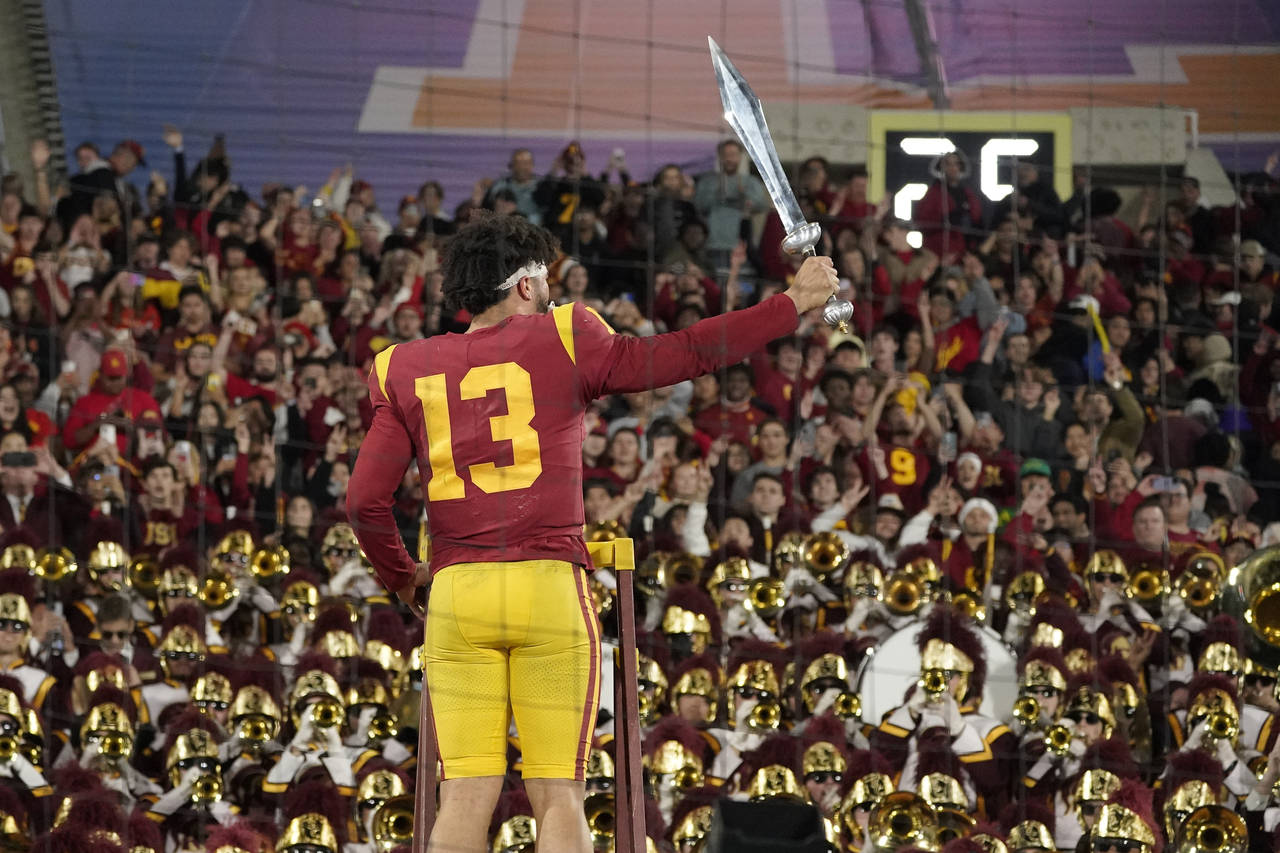 Southern California quarterback Caleb Williams leads the USC Marching Band after USC defeat UCLA 48...