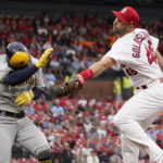 
              FILE -  Milwaukee Brewers' Luis Urias, left, is safe at first as he avoids the tag from St. Louis Cardinals first baseman Paul Goldschmidt during the second inning of a baseball game May 26, 2022, in St. Louis. Cardinals shortstop Edmundo Sosa was charged with a throwing error on the play. Goldschmidt won the National League MVP award Thursday night, Nov. 17, taking the coveted trophy for the first time after a couple of close calls earlier in his career. The first baseman received 22 of 30 first-place votes and eight seconds for 380 points from a Baseball Writers’ Association of America panel. (AP Photo/Jeff Roberson, File)
            