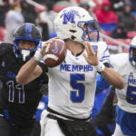 
              Memphis quarterback Seth Henigan (5) throws a pass under pressure from SMU defensive end Je'lin Samuels (11) during the first half of an NCAA college football game at Ford Stadium on Saturday, Nov. 26, 2022, in Dallas. (Smiley N. Pool/The Dallas Morning News via AP)
            