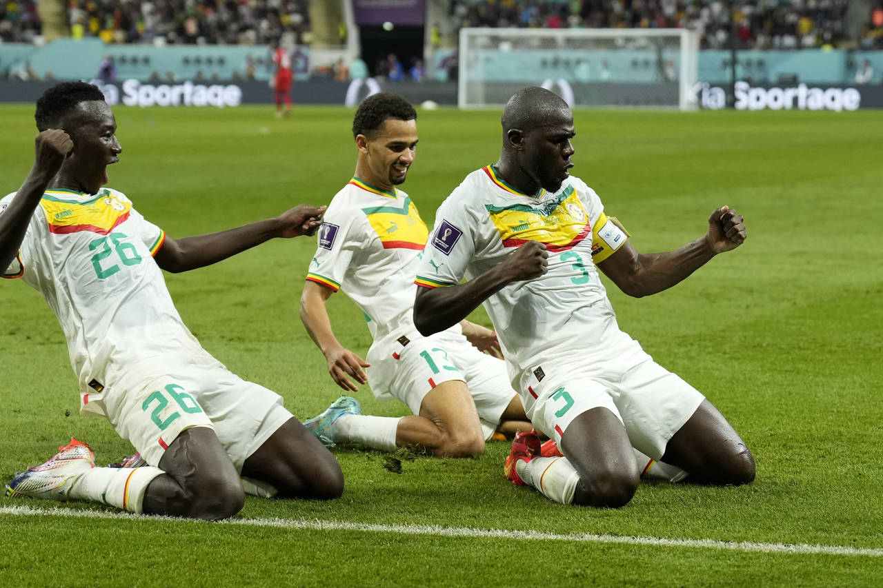 Senegal's Kalidou Koulibaly, right, celebrates with teammates scoring his side's second goal during...