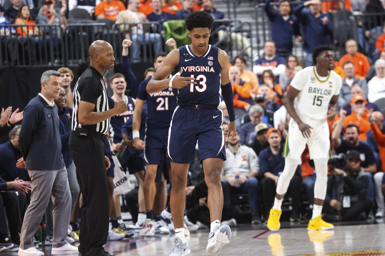 Virginia guard Ryan Dunn (13) celebrates after a play against Baylor during the second half of an N...