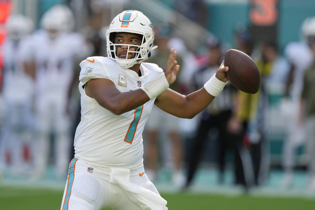 Miami Dolphins quarterback Tua Tagovailoa (1) aims the ball during the first half of an NFL footbal...