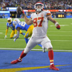 
              Kansas City Chiefs tight end Travis Kelce, right, celebrates a touchdown as Los Angeles Chargers safety Derwin James Jr., left, and cornerback Bryce Callahan get up off the ground during the second half of an NFL football game Sunday, Nov. 20, 2022, in Inglewood, Calif. (AP Photo/Jayne Kamin-Oncea)
            