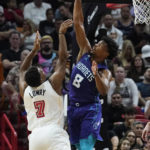 
              Charlotte Hornets guard Dennis Smith Jr. (8) blocks a shot to the basket by Miami Heat guard Kyle Lowry (7) during the first half of an NBA basketball game Thursday, Nov. 10, 2022, in Miami. (AP Photo/Marta Lavandier)
            