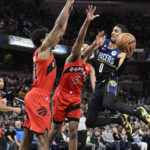 
              Indiana Pacers guard Tyrese Haliburton (0) jumps in front of Toronto Raptors players during the second half of an NBA basketball game, Saturday, Nov. 12, 2022, in Indianapolis, Ind. (AP Photo/Marc Lebryk)
            