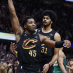 
              Cleveland Cavaliers guard Donovan Mitchell (45) and center Jarrett Allen (31) celebrate the team's 114-113 overtime win over the Boston Celtics in an NBA basketball game Wednesday, Nov. 2, 2022, in Cleveland. (AP Photo/Ron Schwane)
            