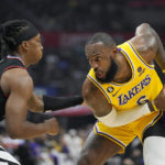 
              Los Angeles Lakers forward LeBron James, right, tries to get past Los Angeles Clippers guard Terance Mann during the first half of an NBA basketball game Wednesday, Nov. 9, 2022, in Los Angeles. (AP Photo/Mark J. Terrill)
            