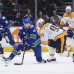
              Vancouver Canucks' Elias Pettersson (40) and Nashville Predators' Matt Duchene (95) vie for the puck during the third period of an NHL hockey game Saturday, Nov. 5, 2022, in Vancouver, British Columbia. (Darryl Dyck/The Canadian Press via AP)
            