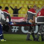 
              Medical staff carry Marseille's Amine Harit out to the pitch during the French League One soccer match between Monaco and Marseille at the Stade Louis II in Monaco, Sunday, Nov. 13, 2022. (AP Photo/Daniel Cole)
            