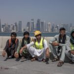 
              FILE - Pakistani migrant laborers pose for a photograph, as they take a break, on the corniche, overlooking the skyline of Doha, Qatar, Wednesday, Oct. 19, 2022. Migrant laborers who built Qatar's World Cup stadiums often worked long hours under harsh conditions and were subjected to discrimination, wage theft and other abuses as their employers evaded accountability, a rights group said in a report released Thursday. (AP Photo/Nariman El-Mofty, File)
            