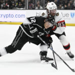 
              Los Angeles Kings left wing Trevor Moore and Ottawa Senators defenseman Jake Sanderson vie for the puck during the second period in an NHL hockey game Sunday, Nov. 27, 2022, in Los Angeles. (AP Photo/John McCoy)
            