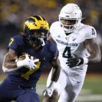 
              Michigan running back Donovan Edwards (7) runs the ball as Michigan State linebacker Jacoby Windmon (4) pursues in the first half of an NCAA college football game in Ann Arbor, Mich., Saturday, Oct. 29, 2022. (AP Photo/Paul Sancya)
            