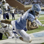 
              North Carolina tight end Bryson Nesbit (18) is tackled just short of the goal line by Georgia Tech defensive back Myles Sims (0) during the first half of an NCAA college football game, Saturday, Nov. 19, 2022, in Chapel Hill, N.C. North Carolina scored a touchdown on the ensuing drive. (AP Photo/Chris Seward)
            