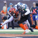 
              Carolina Panthers cornerback Jaycee Horn (8) hits Cincinnati Bengals running back Joe Mixon, left, who carries the ball in for a touchdown during the first half of an NFL football game, Sunday, Nov. 6, 2022, in Cincinnati. (AP Photo/Joshua A. Bickel)
            