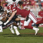 
              Liberty quarterback Johnathan Bennett (11) is tackled by Arkansas linebacker Bumper Pool, right, during the first half of an NCAA college football game Saturday, Nov. 5, 2022, in Fayetteville, Ark. (AP Photo/Michael Woods)
            
