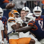 
              UTSA cornerback Nicktroy Fortune, right, breaks up a pass intended for UTEP wide receiver Kelly Akharaiyi, front left, during the first half of an NCAA college football game in San Antonio, Saturday, Nov. 26, 2022. (AP Photo/Eric Gay)
            