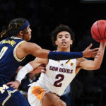 
              Arizona State's Austin Nunez (2) passes the ball away from Michigan's Dug McDaniel (0) during the second half of an NCAA college basketball game in the championship round of the Legends Classic Thursday, Nov. 17, 2022, in New York. Arizona State won 87-62. (AP Photo/Frank Franklin II)
            