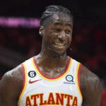 
              Atlanta Hawks forward A.J. Griffin smiles after getting drenched by his teammates during a celebration after he made the winning shot at the buzzer in overtime against the Toronto Raptors in an NBA basketball game, Saturday, Nov. 19, 2022, in Atlanta. (AP Photo/Hakim Wright Sr.)
            