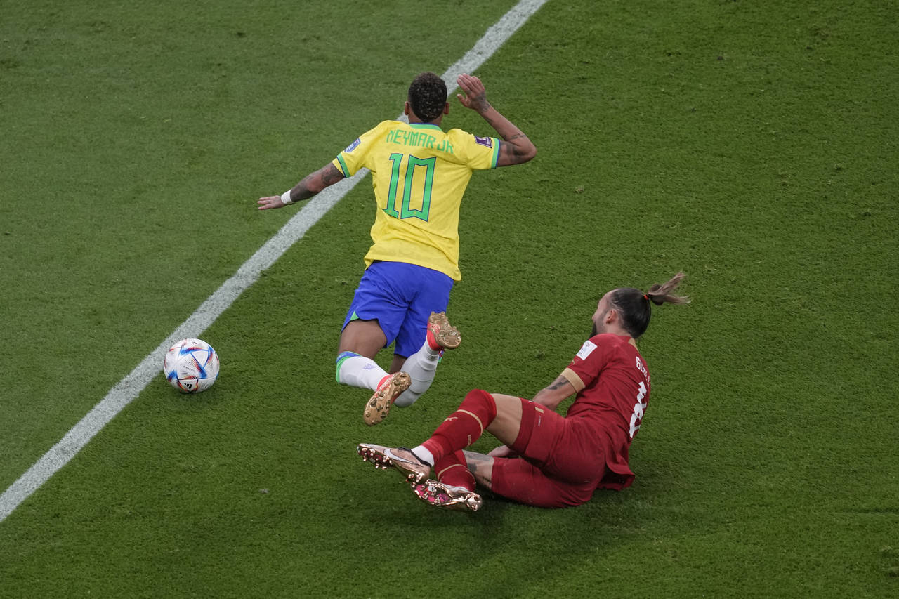 Brazil's Neymar, left, his fouled by Serbia's Nemanja Gudelj during the World Cup group G soccer ma...