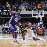 
              Butler guard Eric Hunter Jr. (2) drives under Kansas State forward Nae'Qwan Tomlin (35) in the first half of an NCAA college basketball game in Indianapolis, Wednesday, Nov. 30, 2022. (AP Photo/Michael Conroy)
            