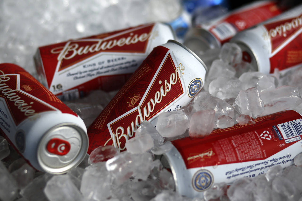 FILE - In this Thursday, March 5, 2015, file photo, Budweiser beer cans are seen at a concession st...