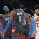 
              Oklahoma City Thunder forward Luguentz Dort, left, celebrates with teammate Jalen Williams (8) as Toronto Raptors guard Fred VanVleet (23) walks off the court during a timeout in the first half of an NBA basketball game Friday, Nov. 11, 2022, in Oklahoma City. (AP Photo/Sue Ogrocki)
            