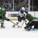 
              St. Louis Blues' Jordan Kyrou (25) shoots the puck against the Dallas Stars during the second period of an NHL hockey game, Monday, Nov. 28, 2022, in St. Louis. (AP Photo/Michael Thomas)
            