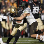
              Colorado running back Alex Fontenot, left, is tackled after a short gain by Oregon defensive back Bennett Williams in the second half of an NCAA college football game, Saturday, Nov. 5, 2022, in Boulder, Colo. (AP Photo/David Zalubowski)
            