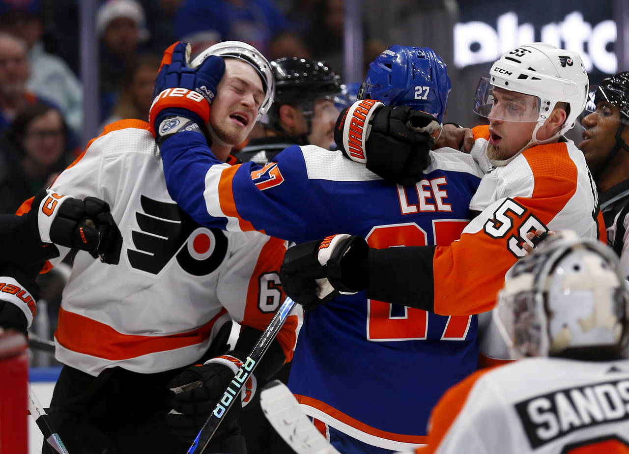 New York Islanders left wing Anders Lee (27) hits Philadelphia Flyers defenseman Travis Sanheim (6)...