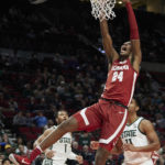 
              Alabama forward Brandon Miller (24) dunks in front of Michigan State guard A.J. Hoggard, right, and guard Pierre Brooks during the first half of an NCAA college basketball game in the Phil Knight Invitational tournament in Portland, Ore., Thursday, Nov. 24, 2022. (AP Photo/Craig Mitchelldyer)
            