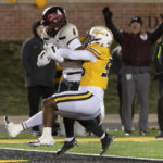 
              New Mexico State running back Star Thomas, left, scores a touchdown past Missouri defensive lineman Arden Walker, right, during the third quarter of an NCAA college football game Saturday, Nov. 19, 2022, in Columbia, Mo. (AP Photo/L.G. Patterson)
            