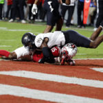 
              North Carolina State's Keyon Lesane (15) is tackled in the end zone after scoring by Wake Forest's DaShawn Jones, top, during the first half of an NCAA college football game in Raleigh, N.C., Saturday, Nov. 5, 2022. (AP Photo/Karl B DeBlaker)
            