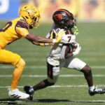 
              Oregon State wide receiver Silas Bolden (7) gets shoved out of bounds by Arizona State defensive back Ed Woods during the first half of an NCAA college football game in Tempe, Ariz., Saturday, Nov. 19, 2022. (AP Photo/Ross D. Franklin)
            