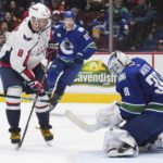 
              Washington Capitals' Alex Ovechkin (8) is stopped by Vancouver Canucks goalie Spencer Martin (30) during the third period of an NHL hockey game Tuesday, Nov. 29, 2022, in Vancouver, British Columbia. (Darryl Dyck/The Canadian Press via AP)
            