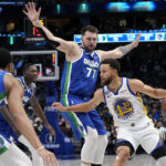 
              Golden State Warriors guard Stephen Curry (30) attempts to get to the basket as Dallas Mavericks' Spencer Dinwiddie (26), Dorian Finney-Smith, center left, and Luka Doncic (77) defend in the second half of an NBA basketball game in Dallas, Tuesday, Nov. 29, 2022. (AP Photo/Tony Gutierrez)
            
