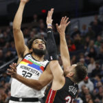 
              Minnesota Timberwolves center Karl-Anthony Towns (32) shoots over Miami Heat guard Max Strus (31) in the first quarter of an NBA basketball game Monday, Nov. 21, 2022, in Minneapolis. (AP Photo/Bruce Kluckhohn)
            